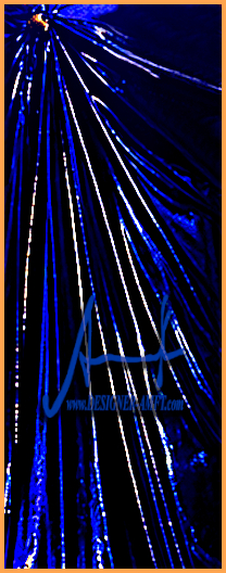 Detail view of the textile draping structure on a luxury metallic summer dress designed by fashion designer Torsten Amft.