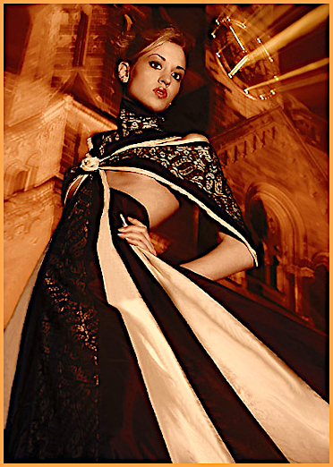 top fashion model Vera Gafron in a black - cream colored gala robe with a handcrafted textile Rose flower from German fashion designer Torsten Amft - Berlin.